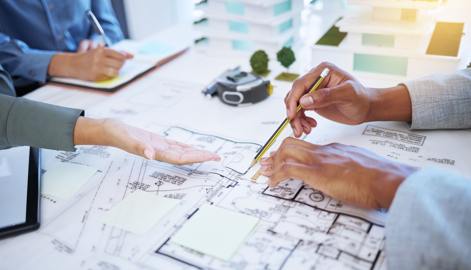 Hands of architecture blueprint design, 3d property construction building and engineering model planning. Creative team collaboration on floor plan sketch, drawing development and industrial project