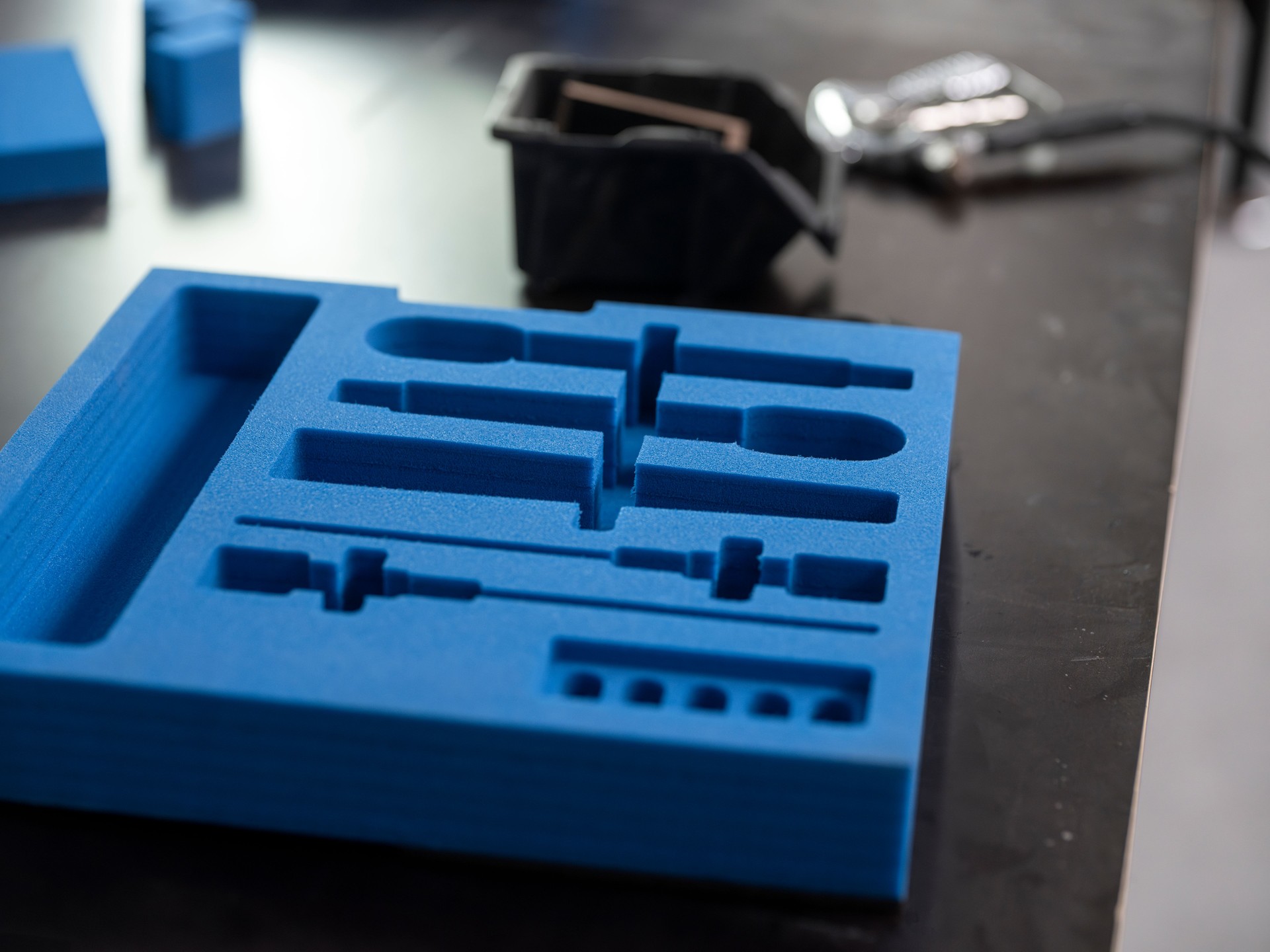Custom blue foam insert with precision-cut compartments for equipment organization